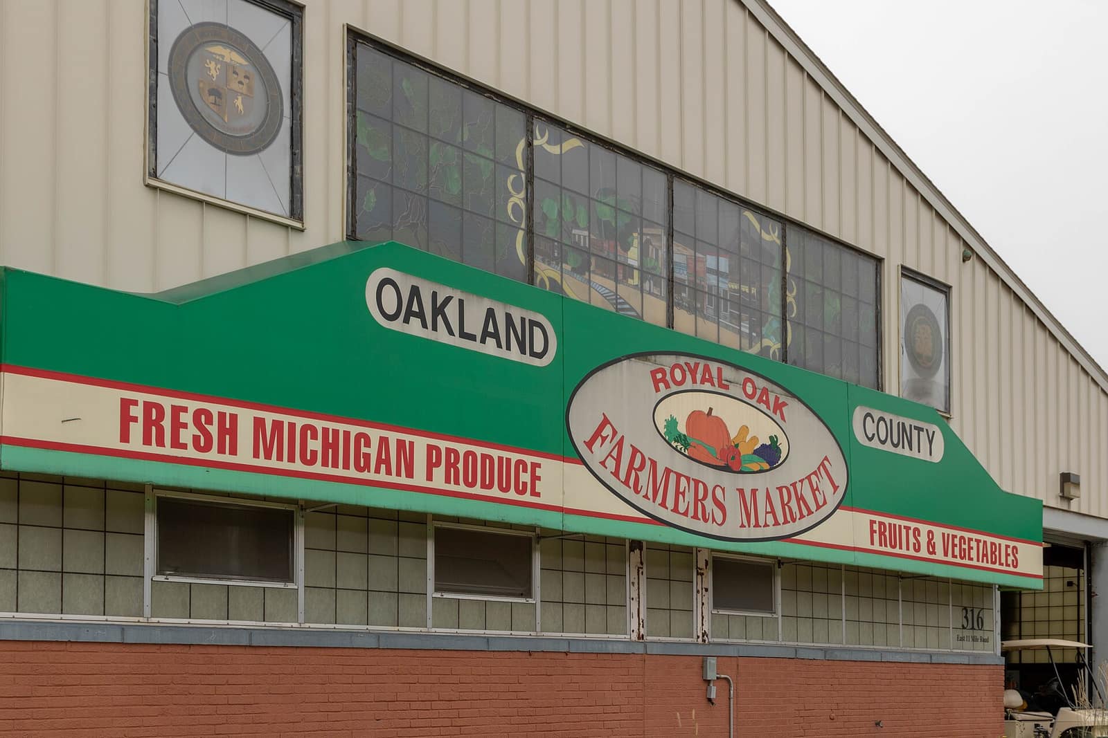 The green awning and Royal Oak Farmers Market sign on the market building on East 11 Mile Road in Royal Oak, Michigan.